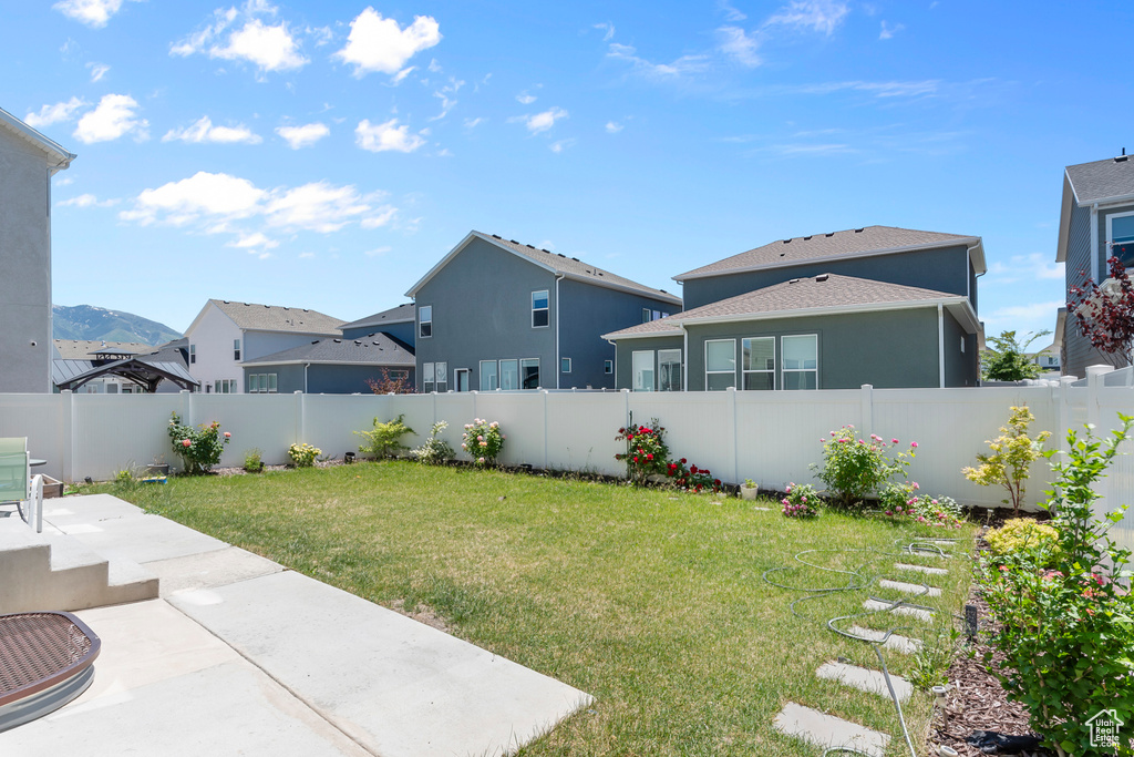 View of yard featuring a patio and a residential view