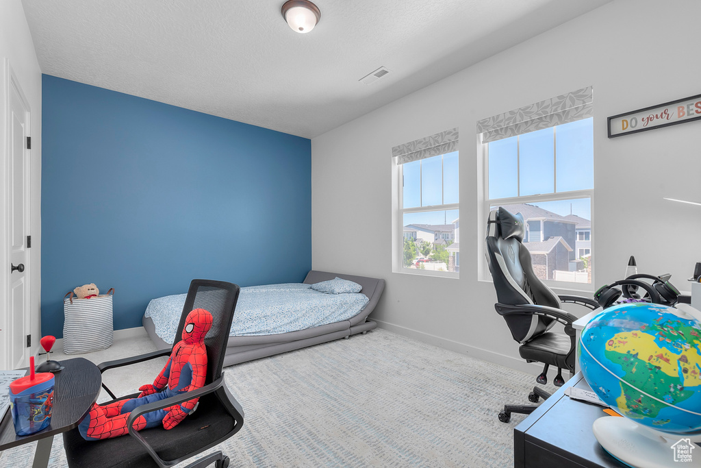 Carpeted bedroom with baseboards