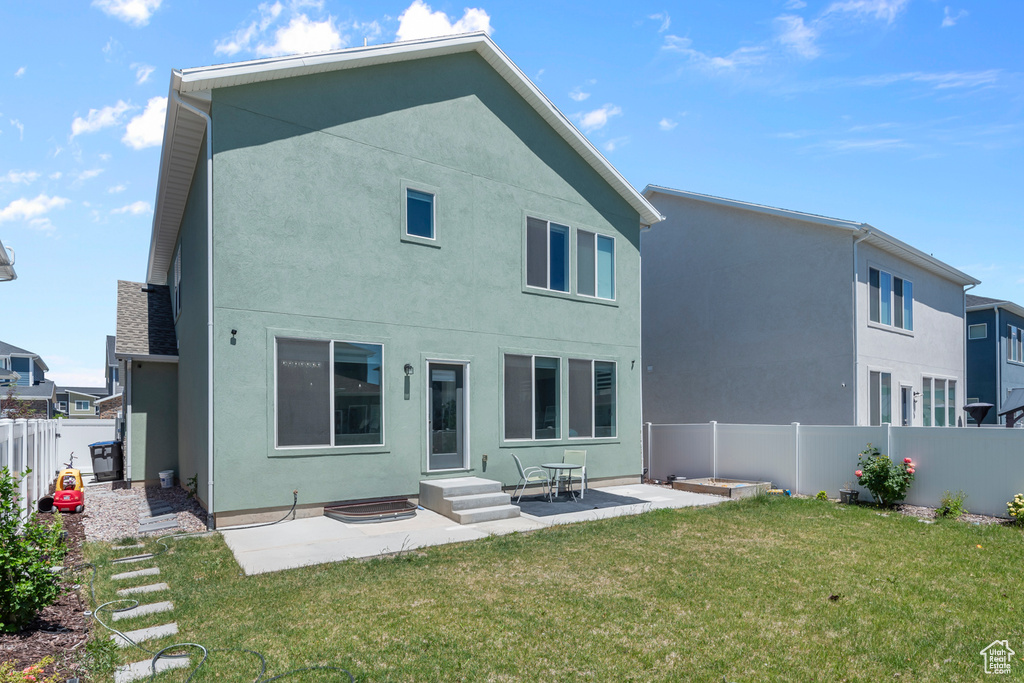Back of property featuring stucco siding, a patio area, and entry steps
