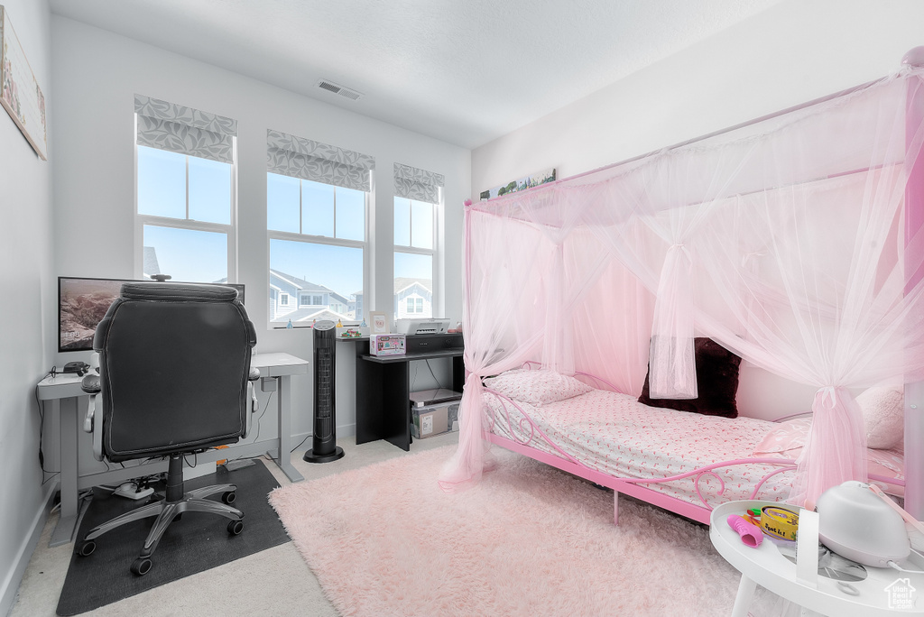 Bedroom with a desk and carpet flooring