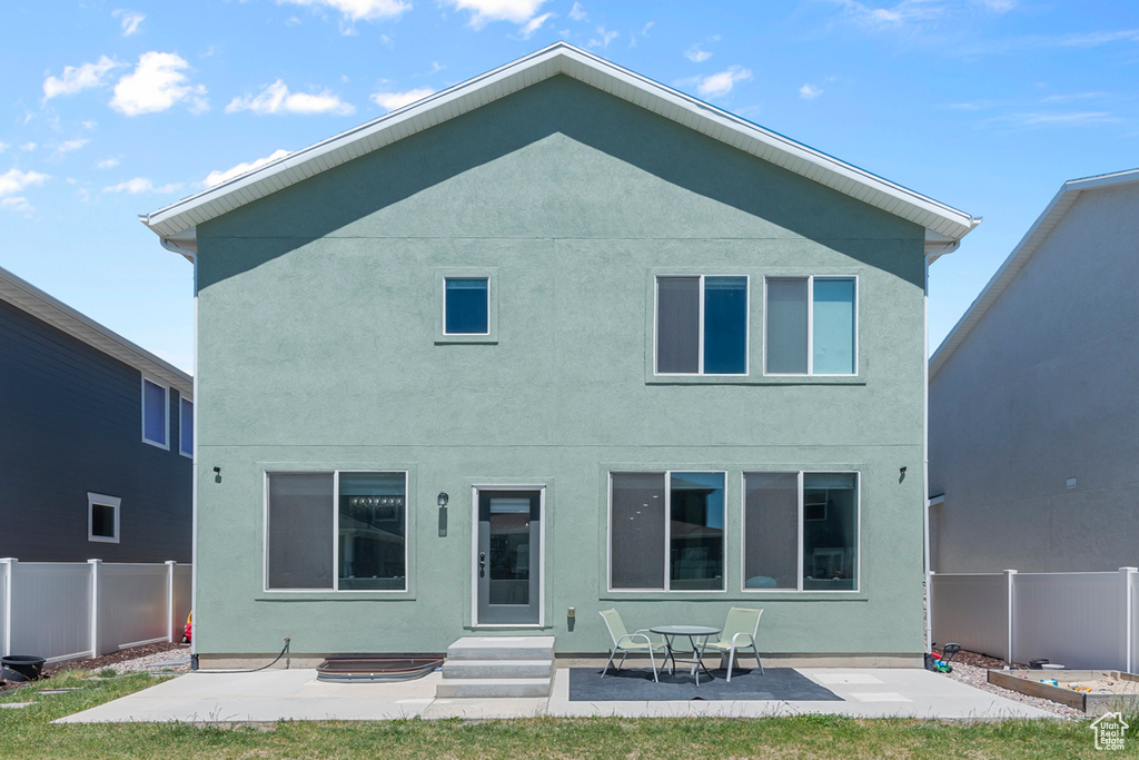 Back of property featuring stucco siding and a patio