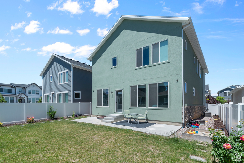 Back of property featuring stucco siding and a patio area