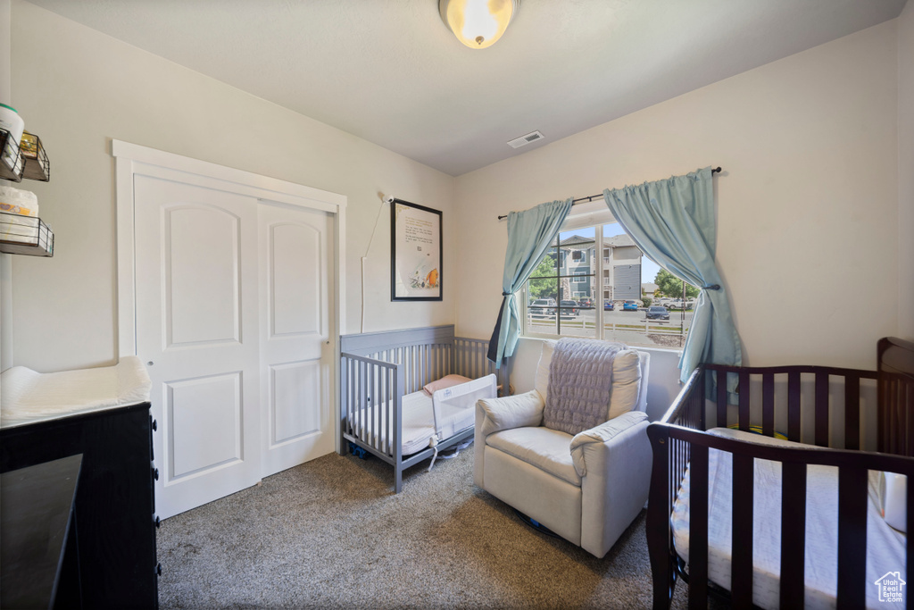 Bedroom with carpet and a closet