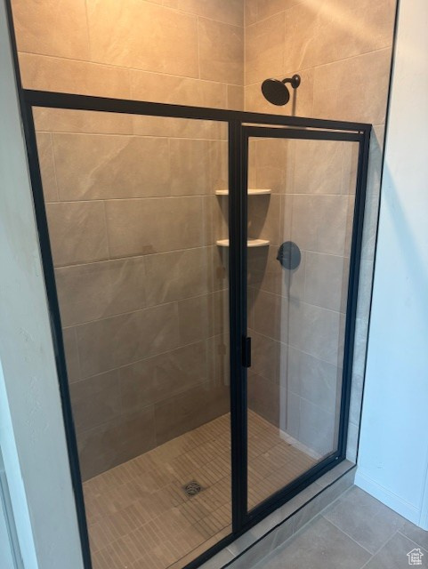 Full bathroom with a shower stall and tile patterned flooring
