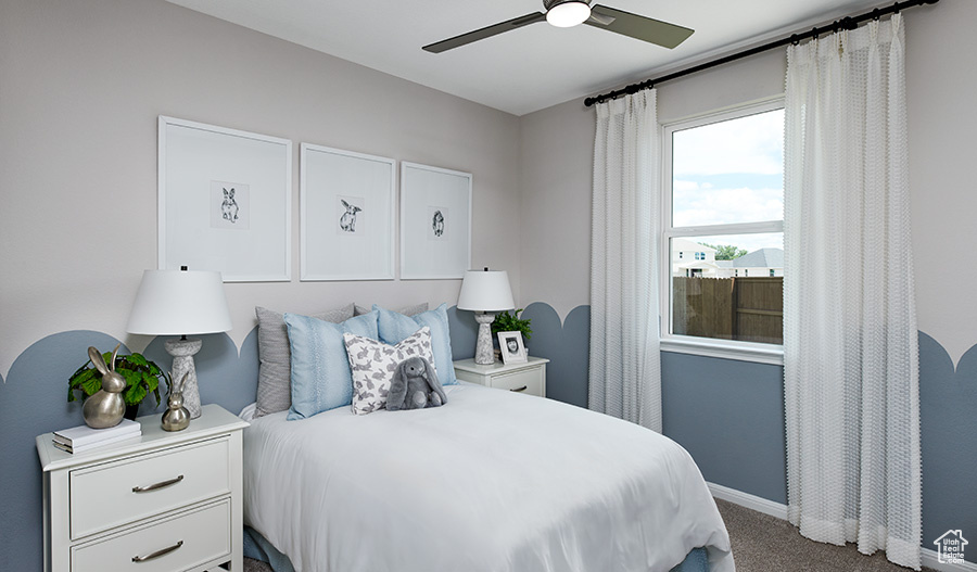 Bedroom featuring carpet, ceiling fan, and baseboards