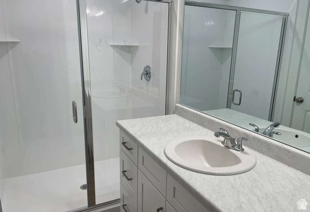 Bathroom featuring vanity and a stall shower