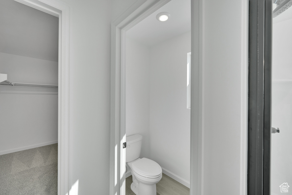 Bathroom with toilet and baseboards