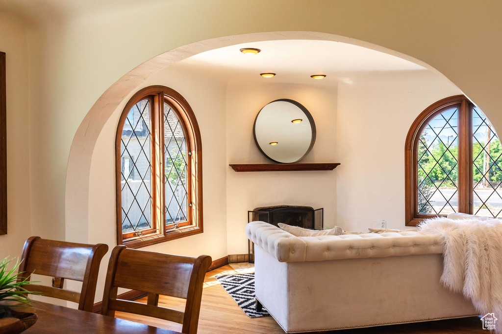 Living room featuring arched walkways, wood finished floors, and baseboards