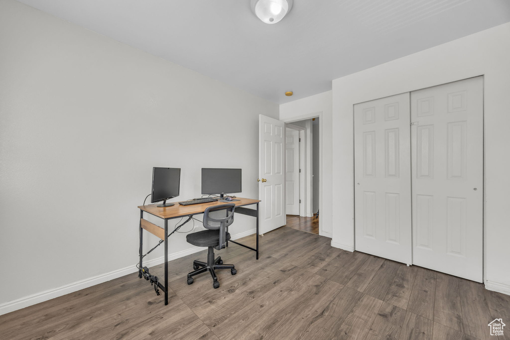 Office with wood finished floors and baseboards