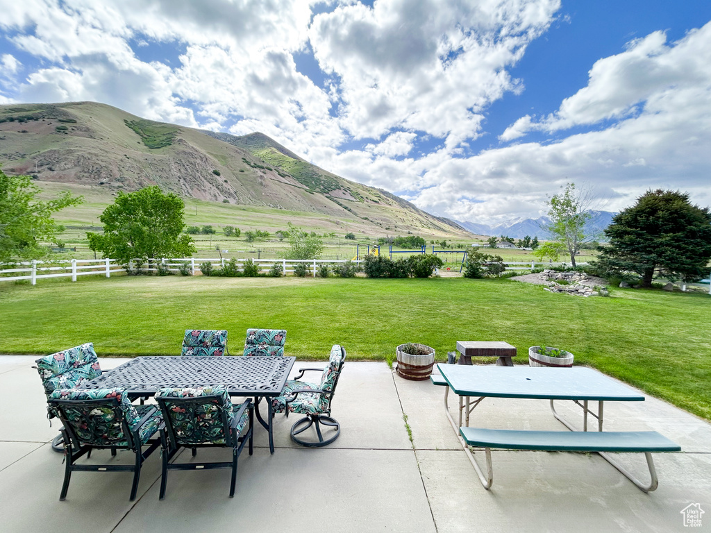 View of patio / terrace with a mountain view and outdoor dining area