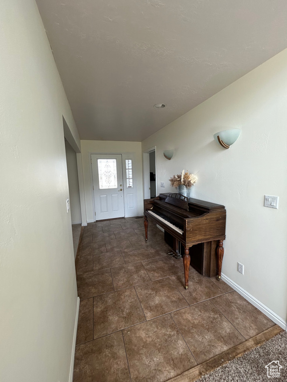 Foyer entrance featuring baseboards