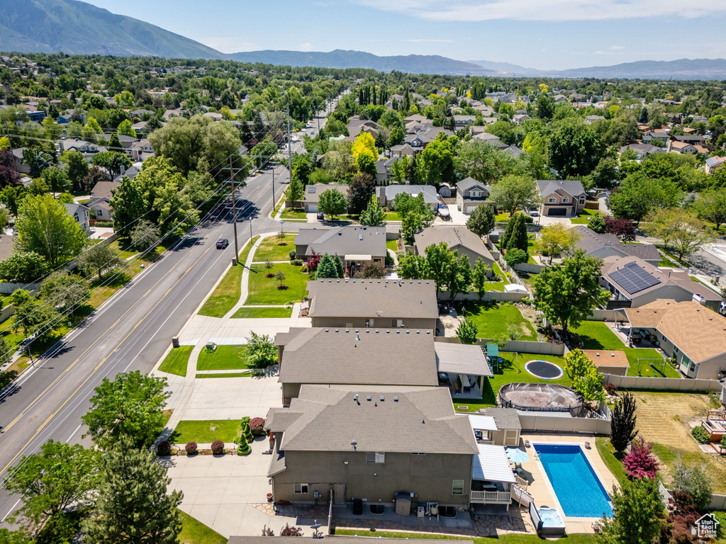 Aerial view of residential area with a mountainous background and a pool area