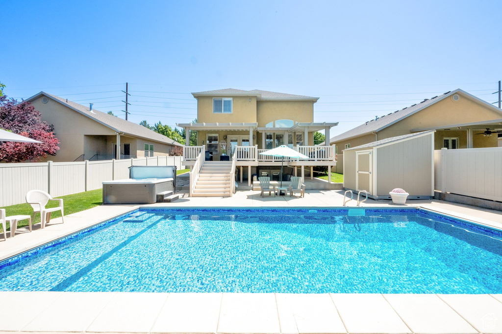 View of pool with a hot tub, a pergola, a fenced backyard, a patio area, and stairs