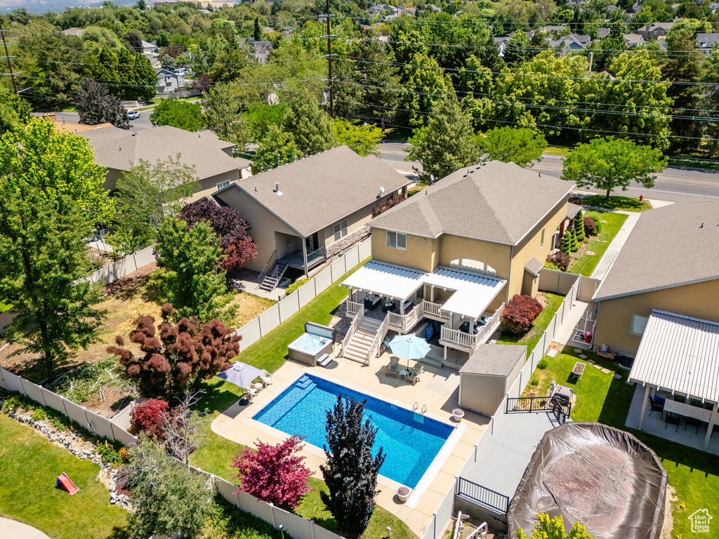 Aerial perspective of suburban area featuring a pool