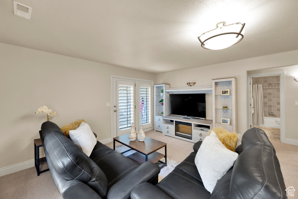 Living room with light colored carpet and baseboards