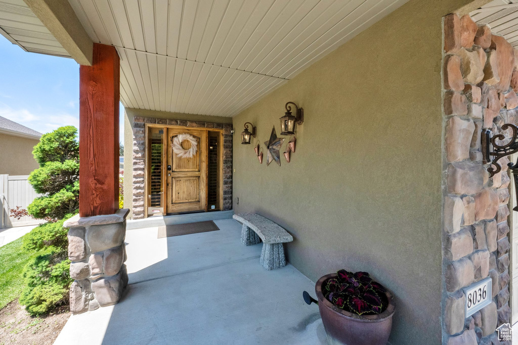 Property entrance with stucco siding and covered porch