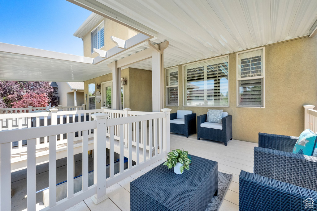 View of patio with an outdoor hangout area and a deck
