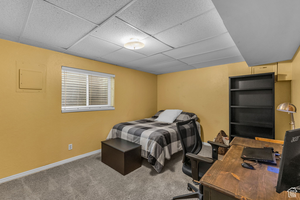 Bedroom featuring carpet flooring, baseboards, a paneled ceiling, and an office area