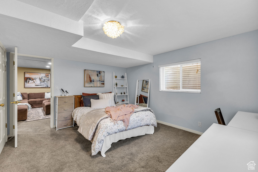 Carpeted bedroom featuring baseboards