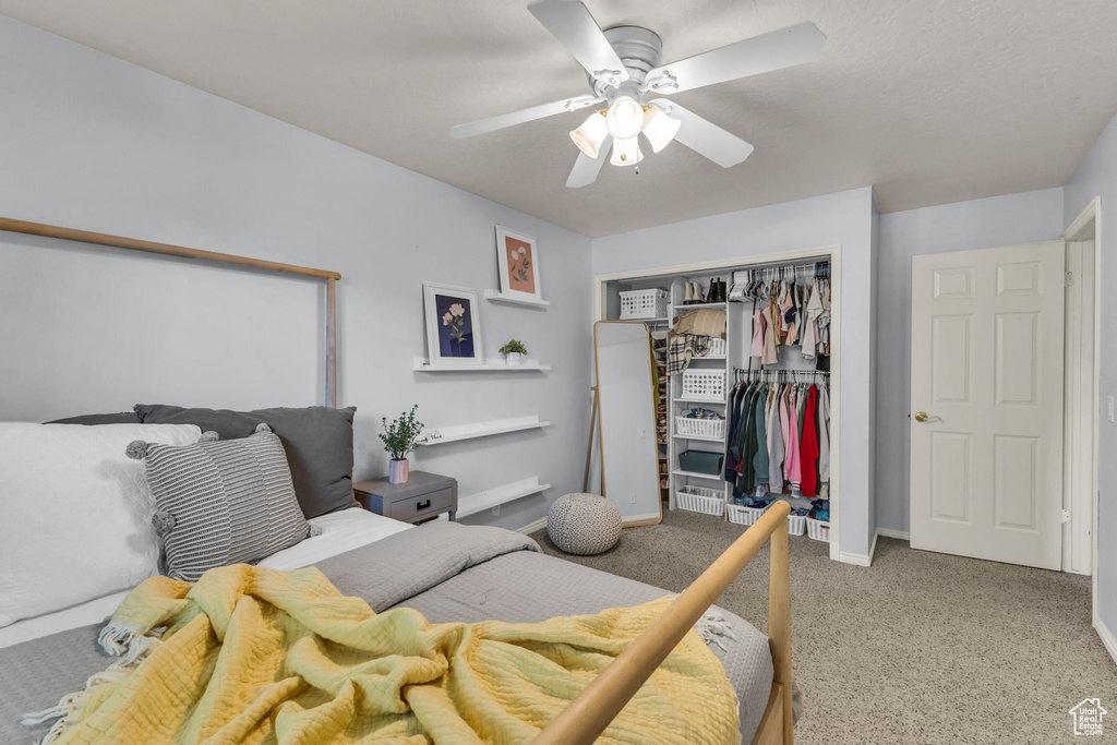 Carpeted bedroom featuring a closet, ceiling fan, and baseboards