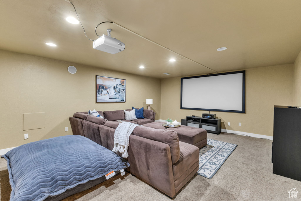 Carpeted home theater with recessed lighting and baseboards