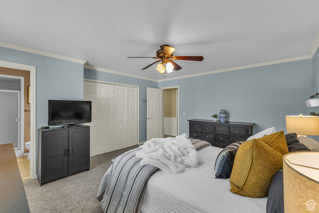 Bedroom with a closet, ornamental molding, a ceiling fan, and ensuite bathroom