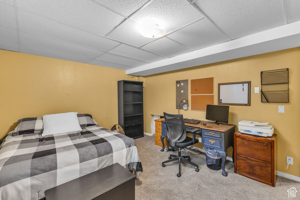 Bedroom with carpet, a paneled ceiling, and baseboards