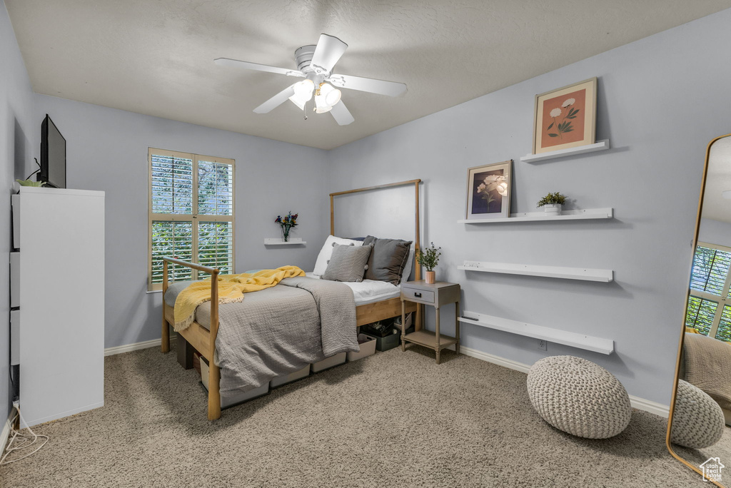 Bedroom with carpet floors, baseboards, and ceiling fan
