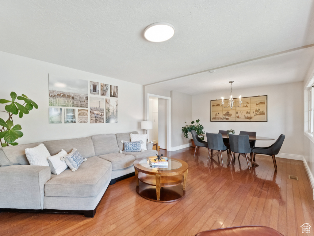 Living area featuring wood-type flooring and a chandelier