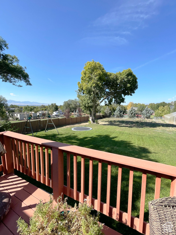 Wooden deck featuring a playground
