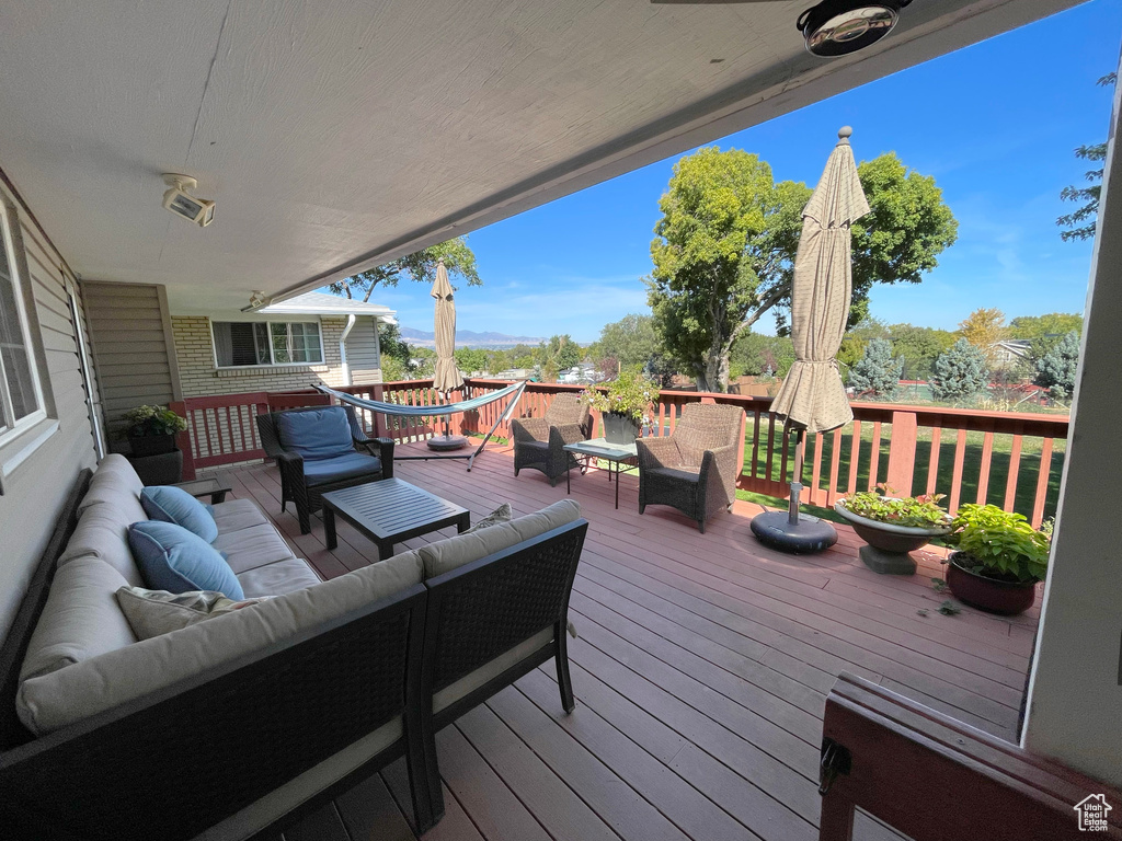 Wooden deck featuring an outdoor living space
