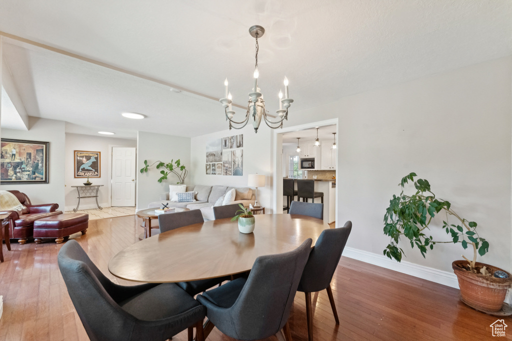 Dining room with a chandelier and hardwood / wood-style flooring