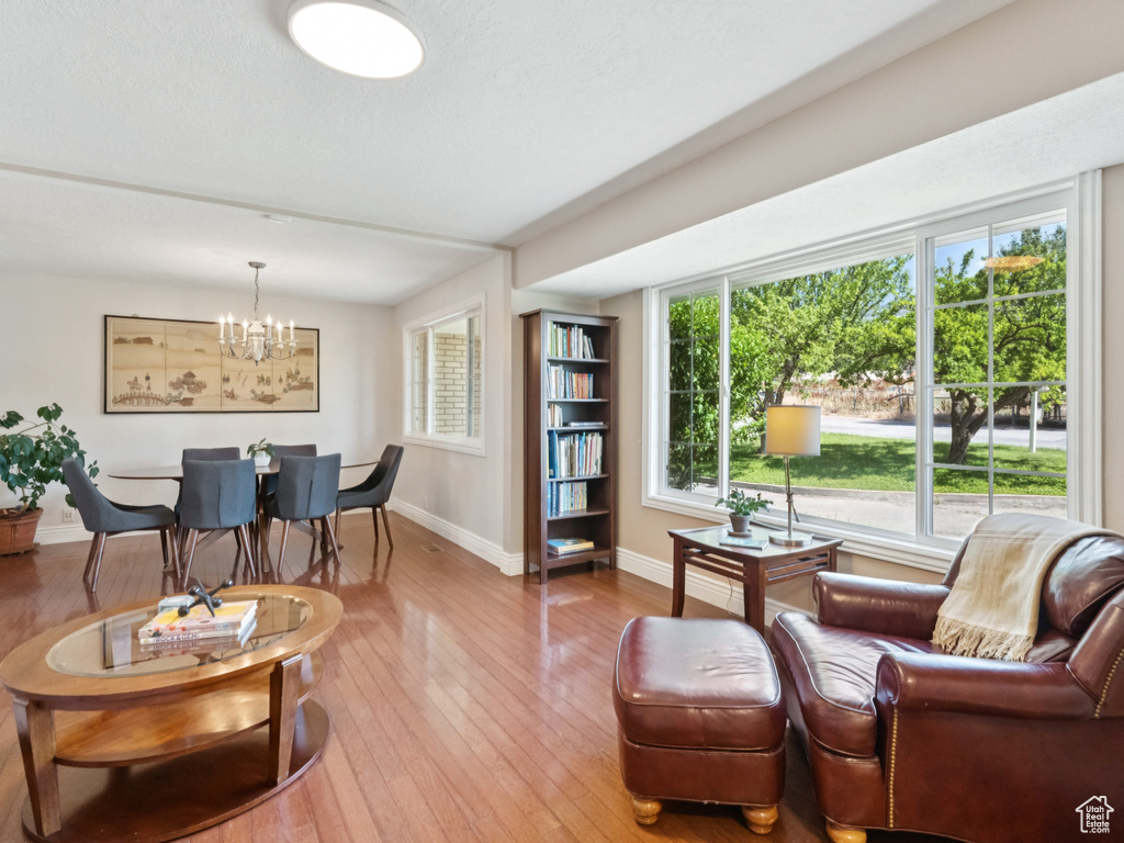 Living room with a chandelier and wood-type flooring