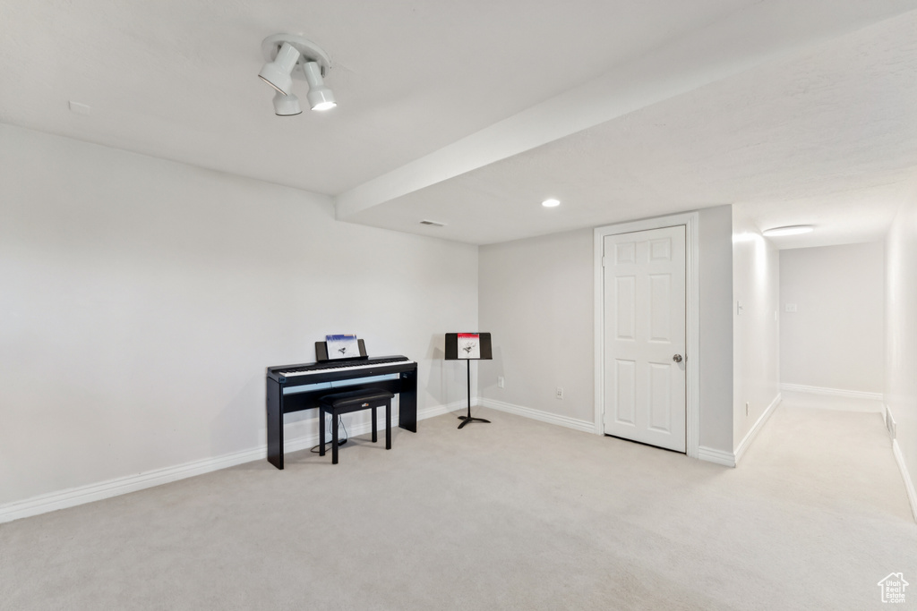 Finished basement featuring light colored carpet and baseboards