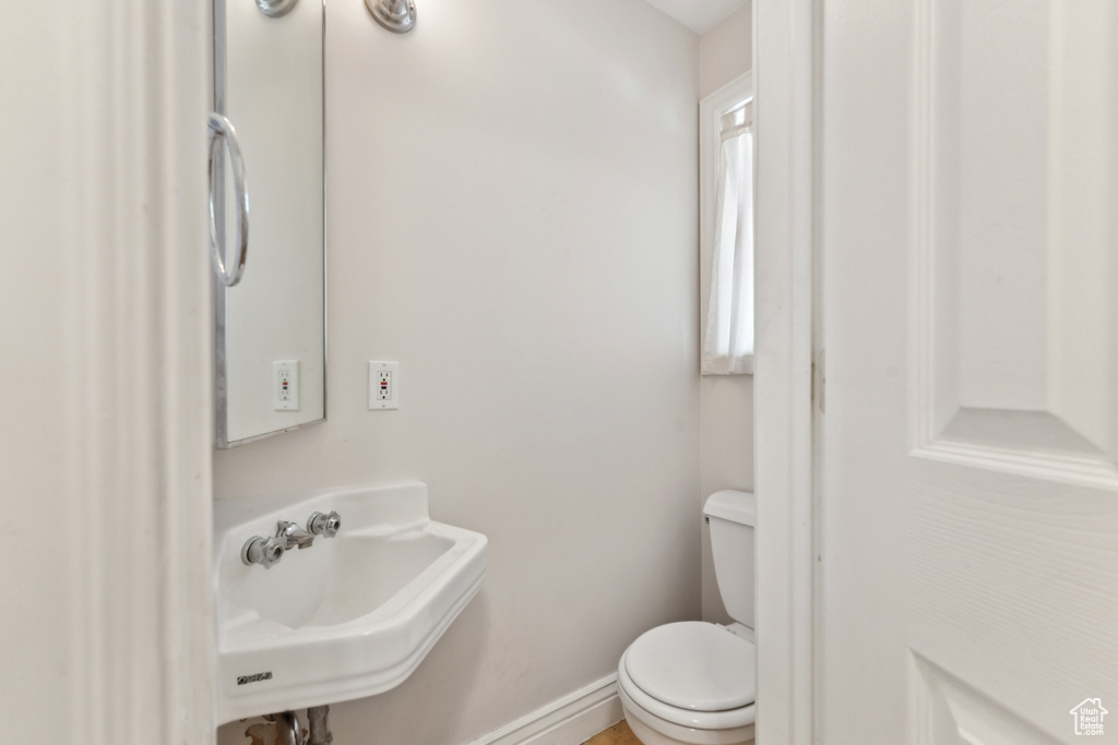 Half bathroom with a sink and toilet