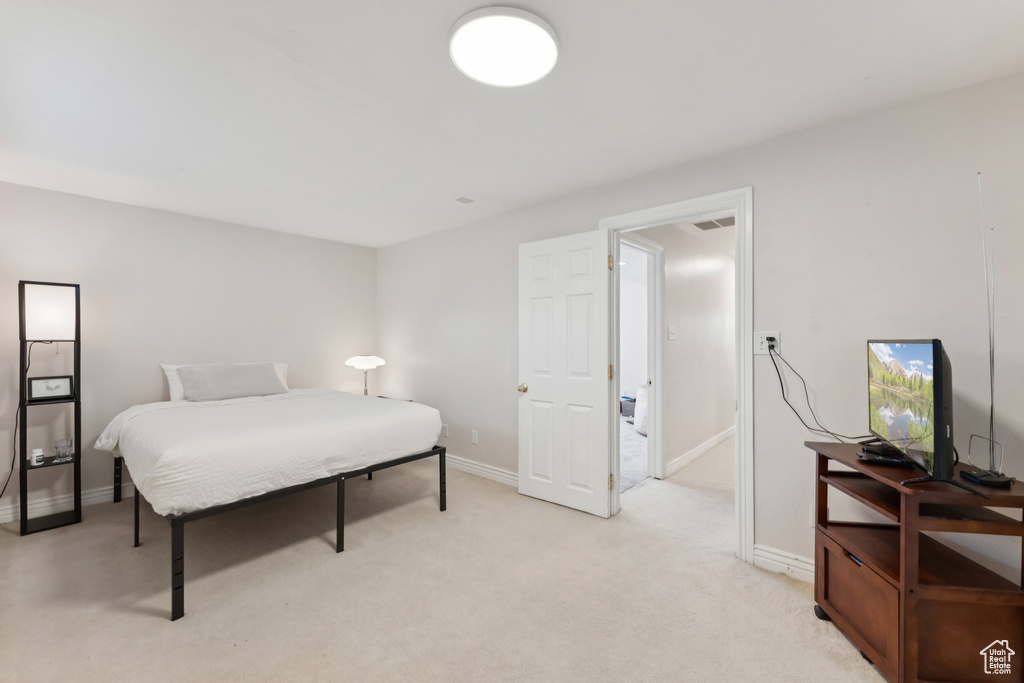 Bedroom featuring baseboards and light colored carpet
