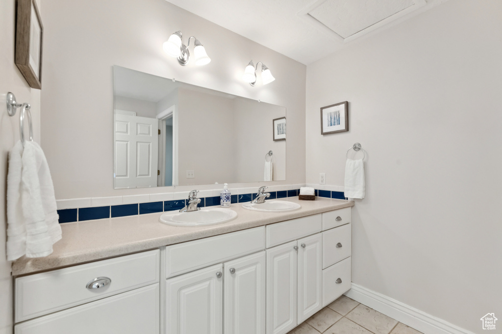 Bathroom featuring double vanity and tile patterned flooring