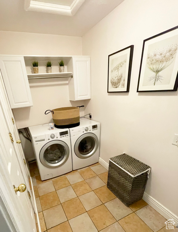 Laundry area featuring cabinet space, independent washer and dryer, and baseboards