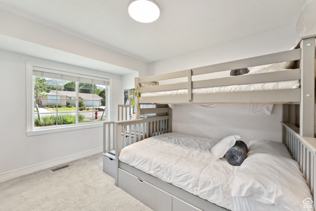Bedroom featuring carpet flooring and baseboards