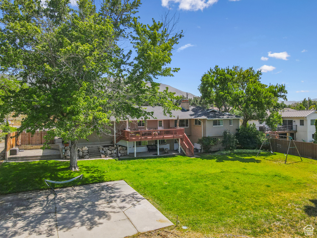 View of yard featuring a patio area, stairway, and a wooden deck