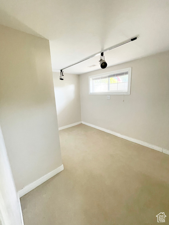 Unfurnished room featuring baseboards and carpet