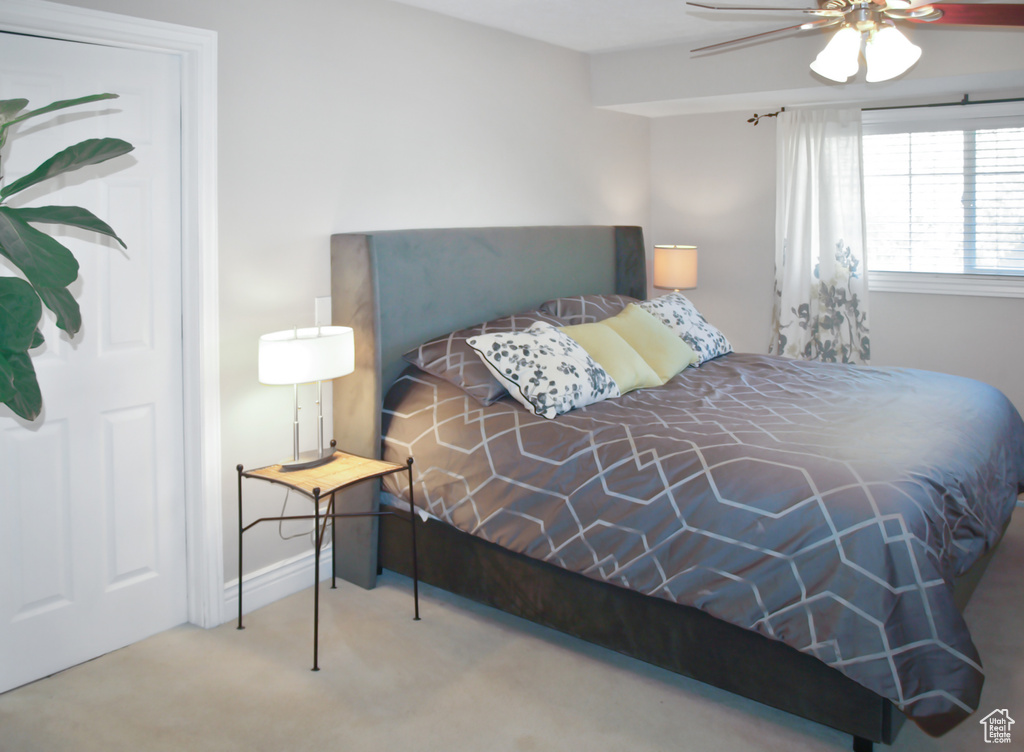 Bedroom featuring carpet floors, baseboards, and ceiling fan