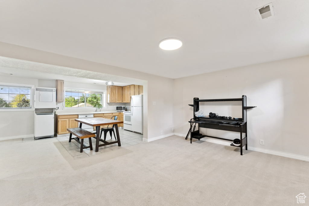 Dining room featuring baseboards and light carpet