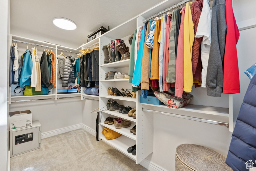Walk in closet with carpet flooring