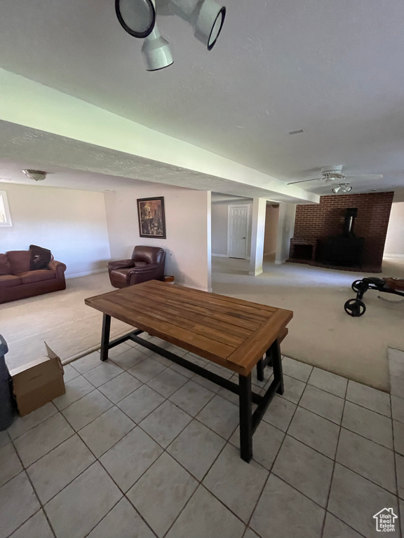Living room with light tile patterned floors and light carpet