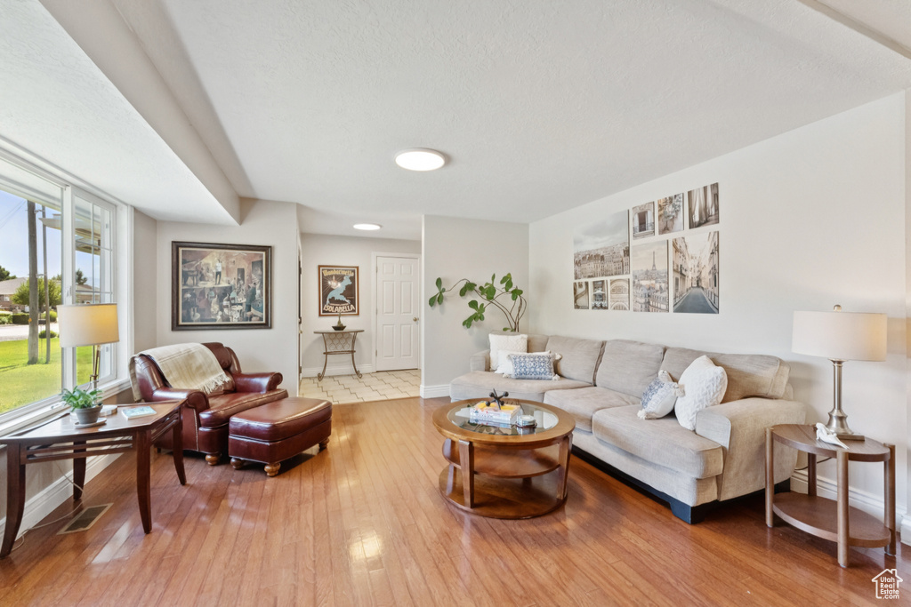 Living area with baseboards and hardwood / wood-style flooring