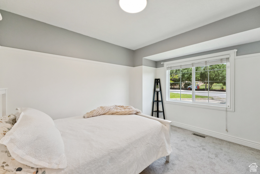 Carpeted bedroom featuring baseboards