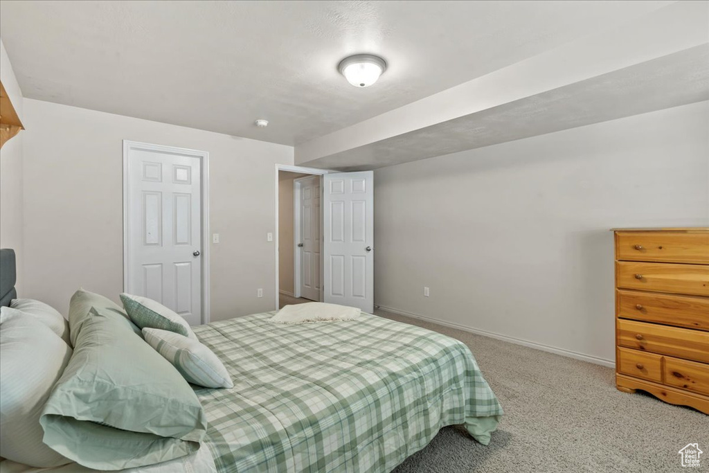 Carpeted bedroom featuring baseboards