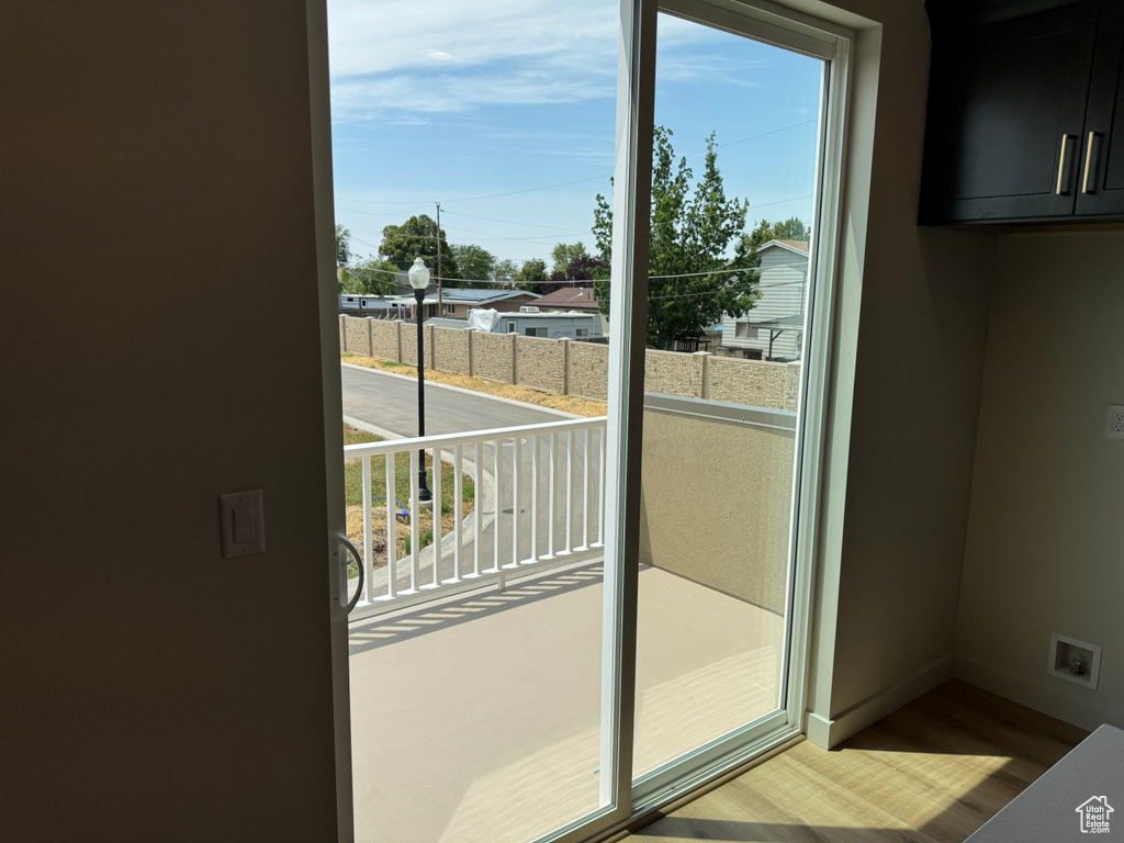 Doorway featuring healthy amount of natural light and wood finished floors