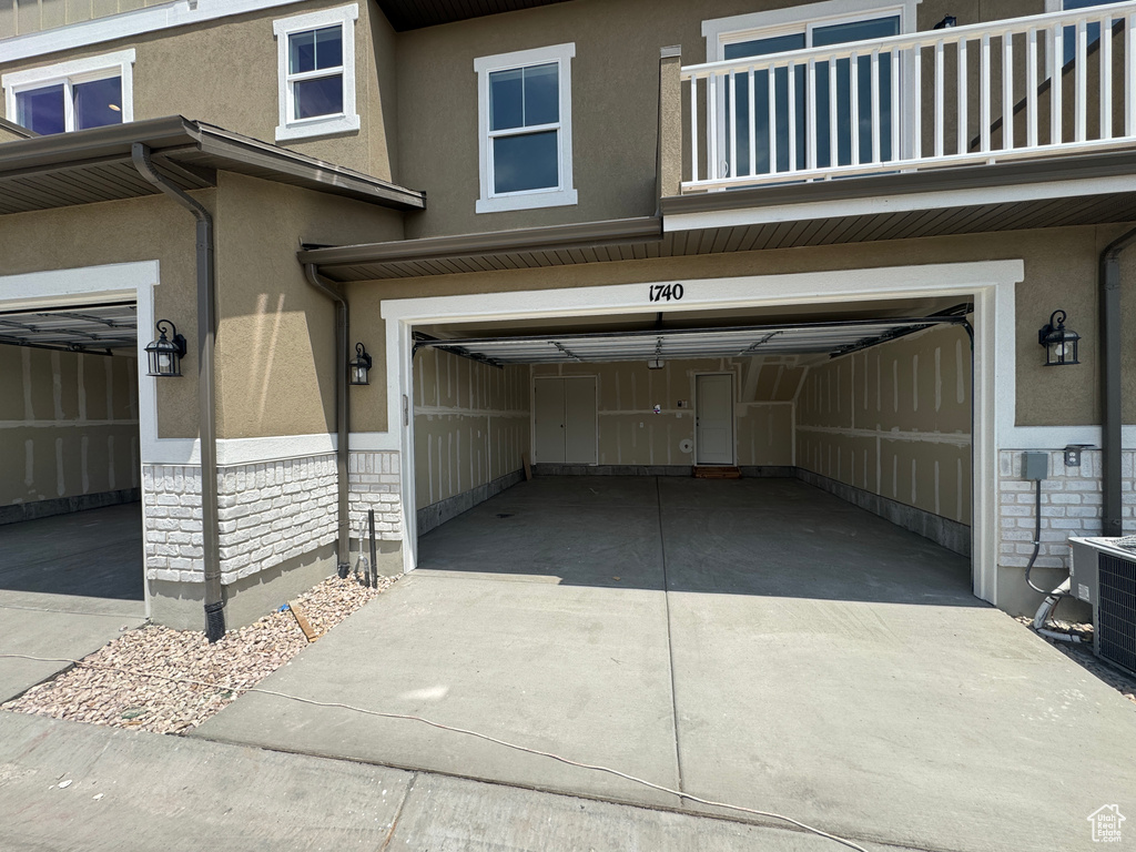 Garage featuring concrete driveway